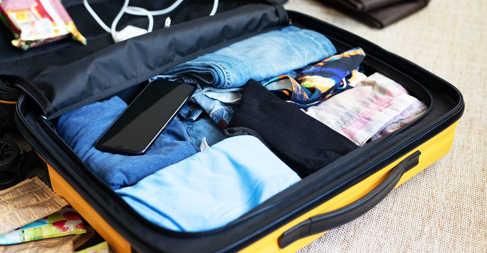 An open suitcase with men’s clothing, packed for a business trip.